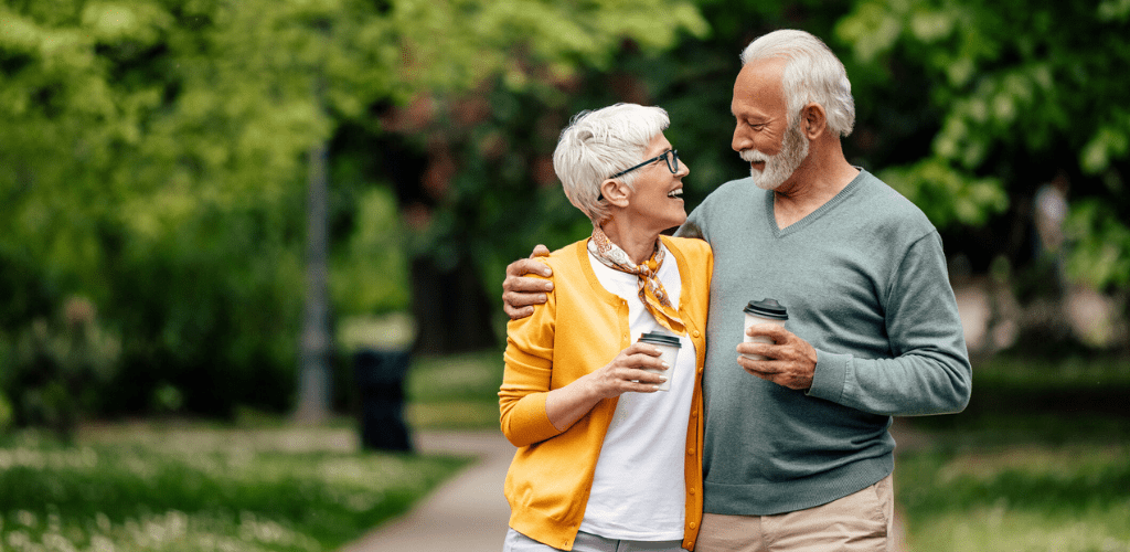 Happy retired couple outside on a walk