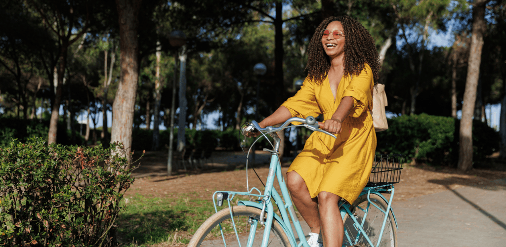 Happy woman riding a bike in spring.