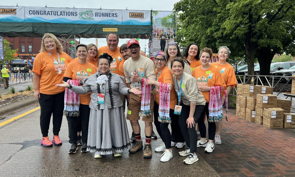 Team members smiling at Grandma's Marathon Finish Line
